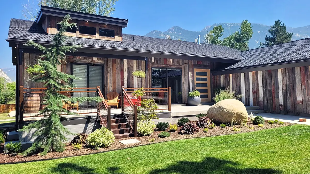 Planting beds and boulders around a mountain-modern home