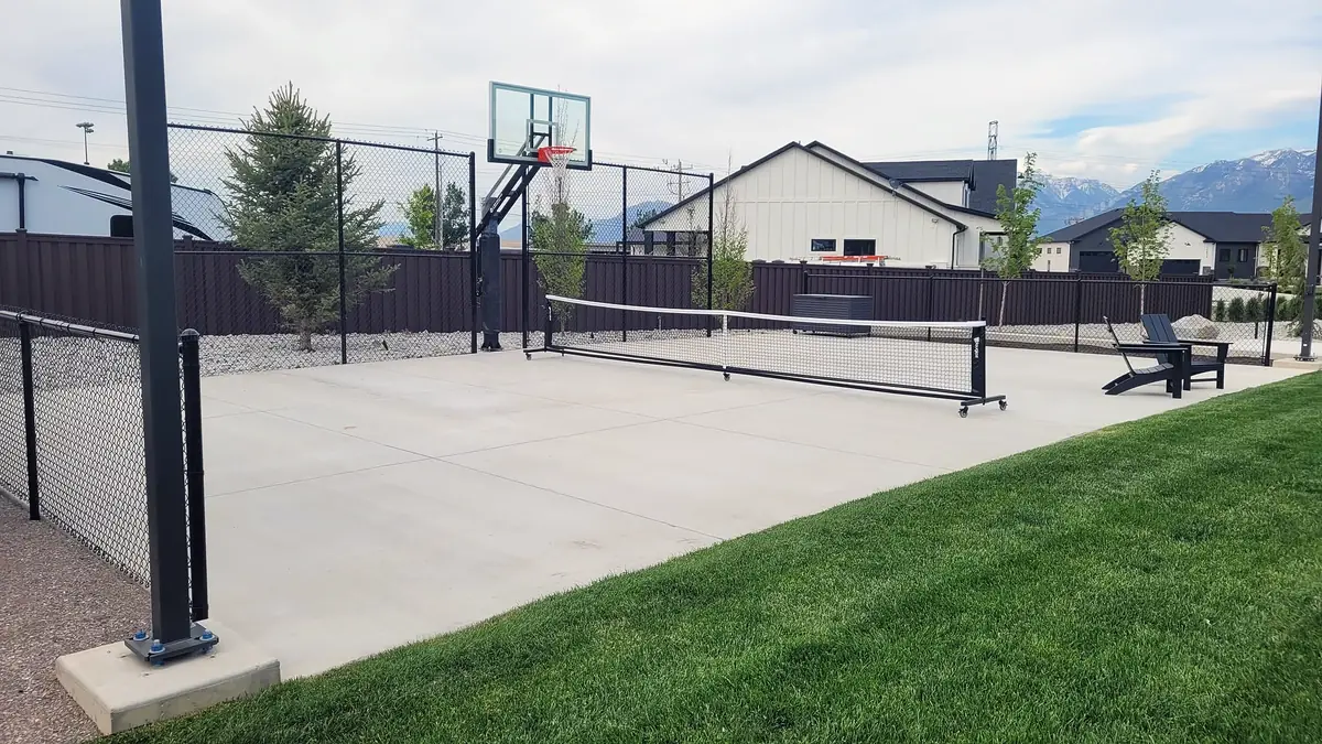 Backyard sport court beside new sod