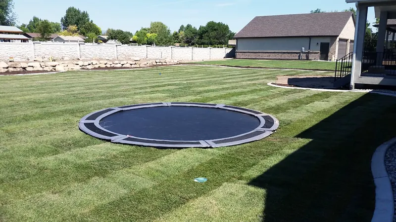 In-ground trampoline set flush in the lawn