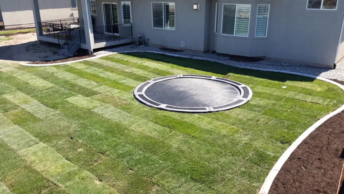 In-ground trampoline with curbing and beds