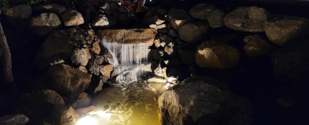 Waterfall lit at night