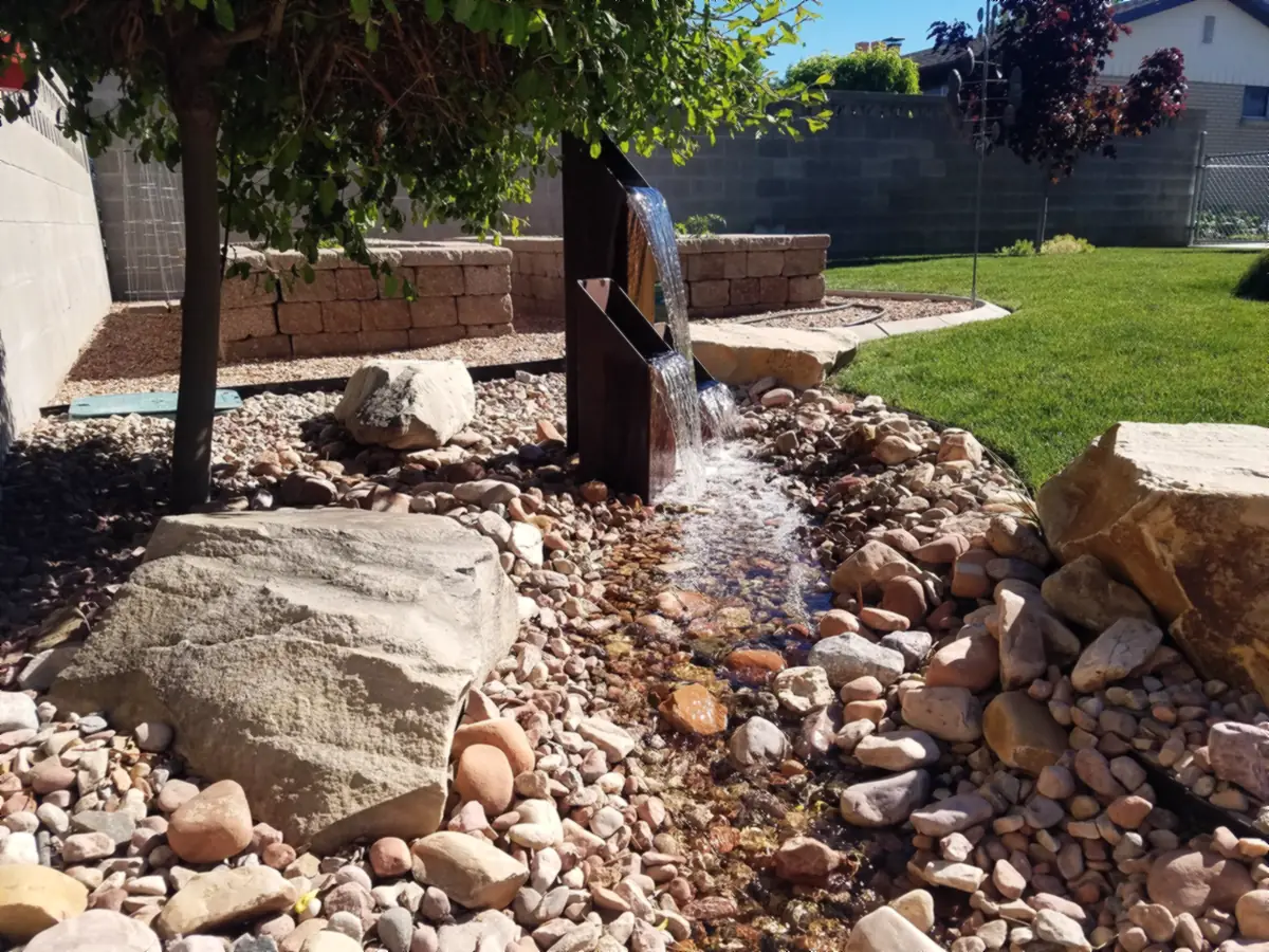 Steel spillway into a rock stream
