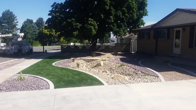 Rock and lawn front yard with curbing