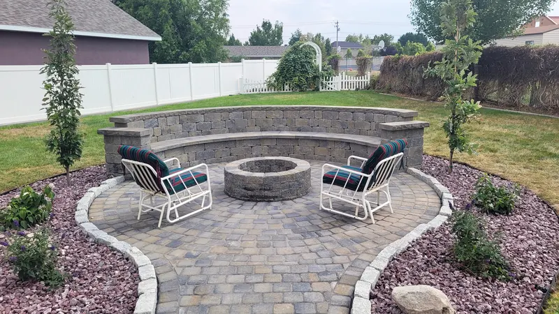 Paver fire pit patio with a seat wall
