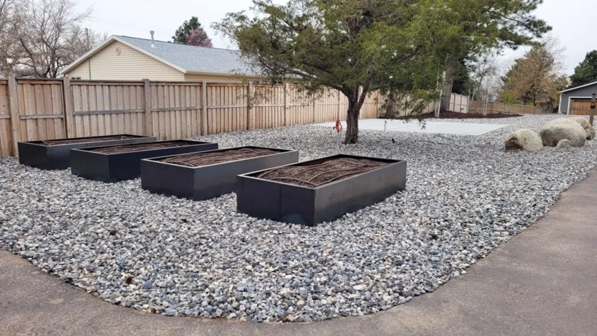 Steel raised garden beds in rock