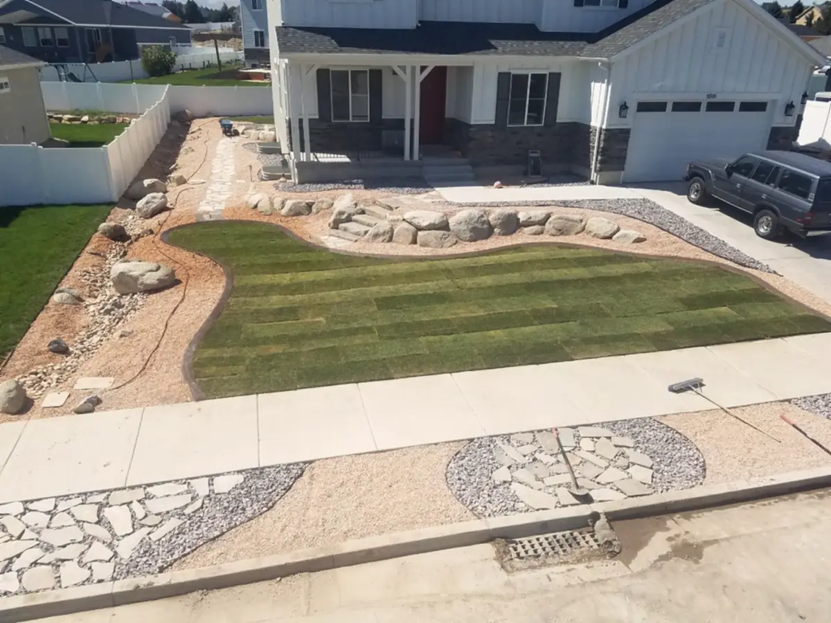 Curved lawn, boulders and a flagstone park strip