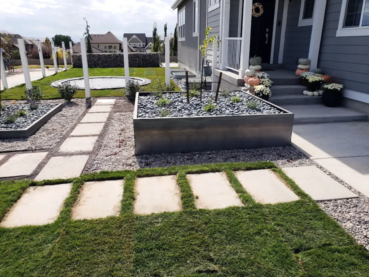 Steel planters and stepping pavers in new sod