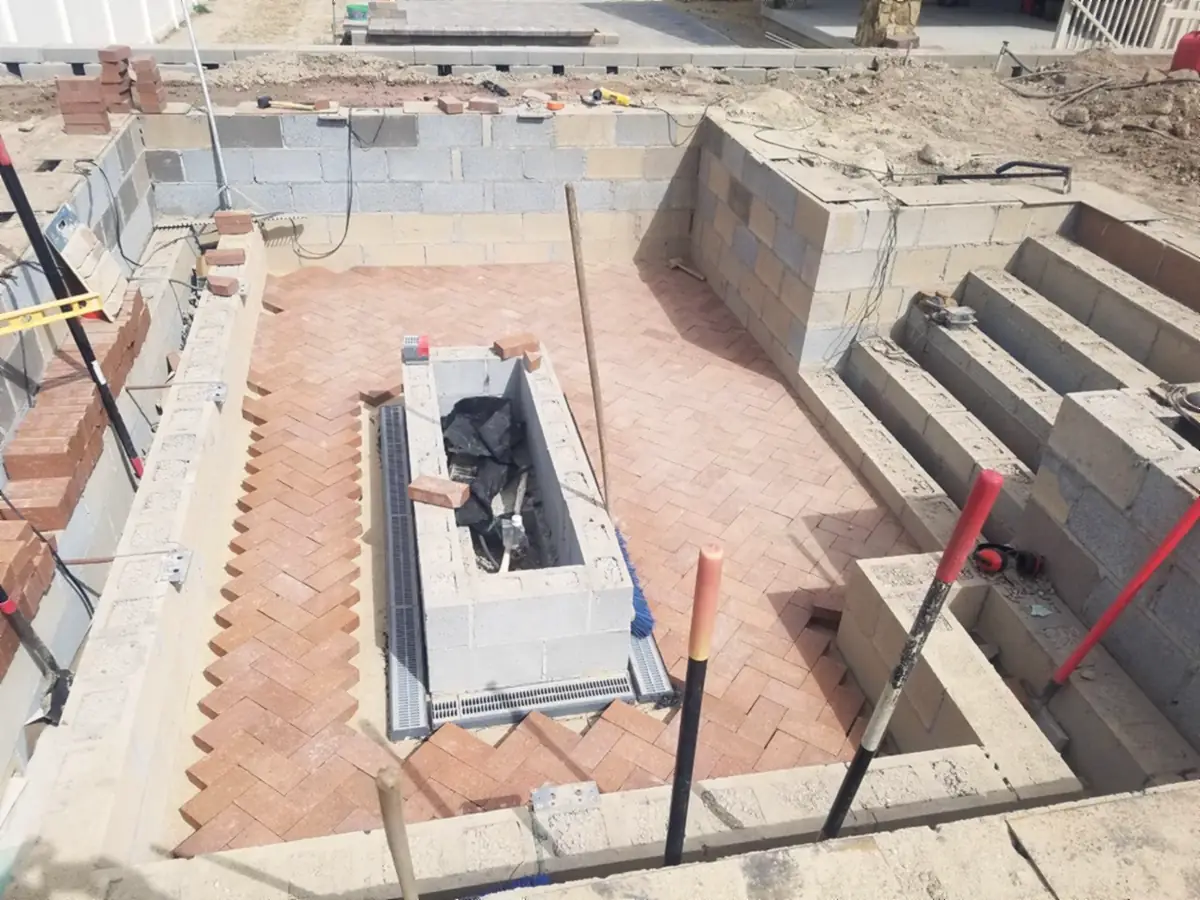 Fire lounge: brick floor and block walls going in