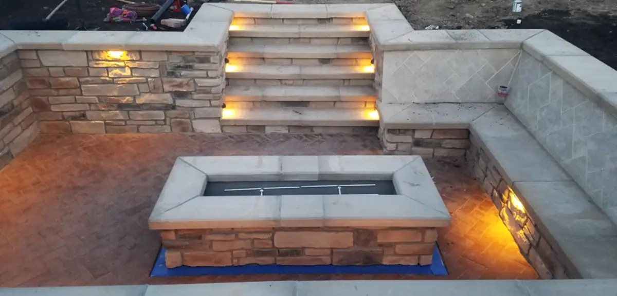 Lit stone steps down into the fire lounge