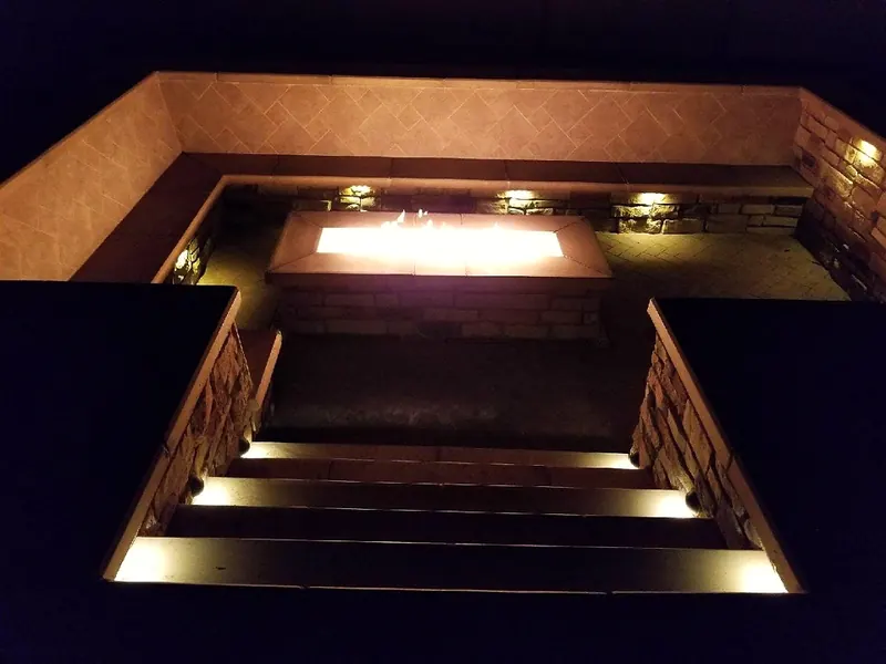Sunken fire lounge at night, lit steps